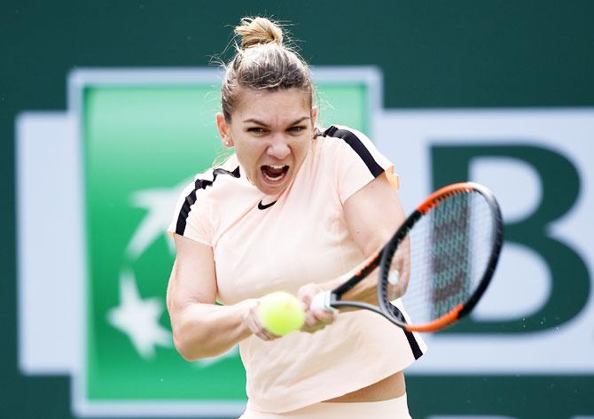 Romania's Simona Halep hits a backhand against China's Qiang Wang