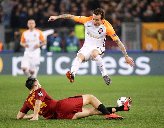 Shakhtar Donetsk's Bernard is challehged by Roma's Konstantinos Manolas