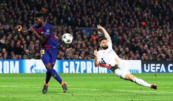 Chelsea's Olivier Giroud shoots at goal past Barcelona’s Samuel Umtiti