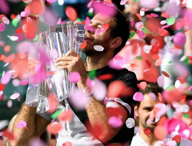  Juan Martin Del Potro poses with the trophy after defeating Roger Federer to win the Indian Wells tennis tournament on March 18