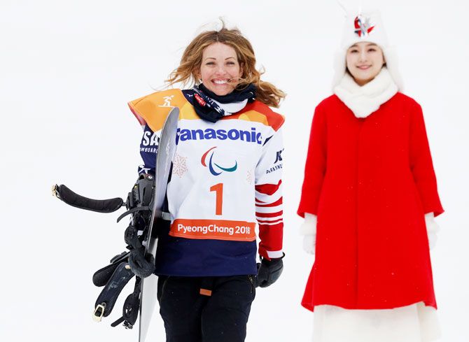 USA's Amy Purdy celebrates winning the bronze in the snowboarding banked slalom event