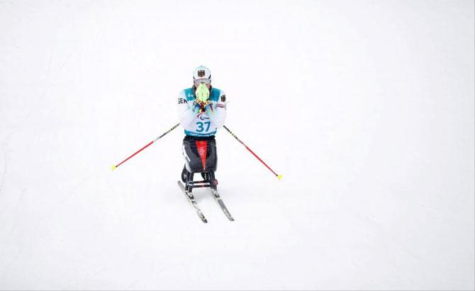 Germany's Martin Fleig celebrates winning gold in the men's 15km biathlon