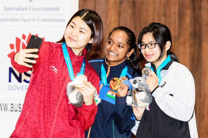 Gold medallist, India's Elavenil Valarivan is flanked by Chinese Taipei's Lin Ying-Shin and China's Wang Zeru as they click a selfie