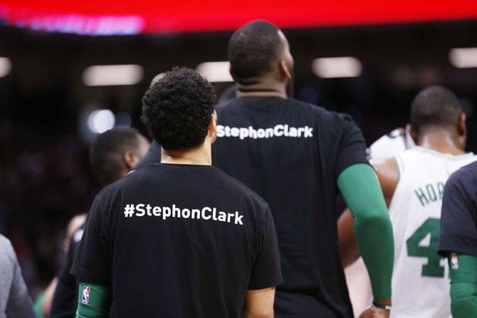 Members of the Boston Celtics stand on the court during a timeout against the Sacramento Kings in the third quarter at Golden 1 Center