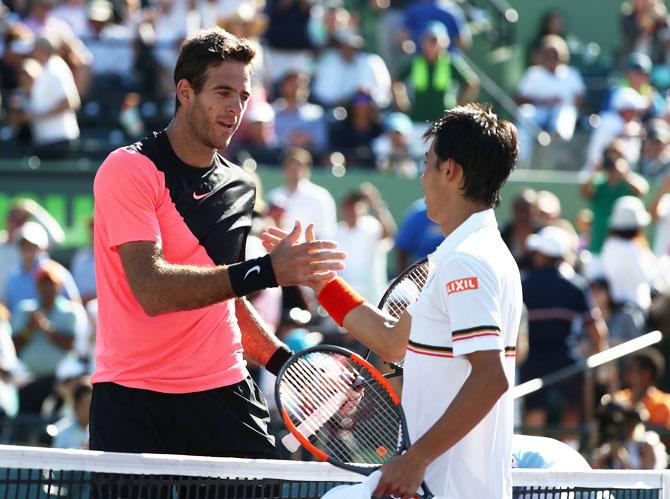 Argentina's Juan Martin Del Potro is congratulated by Japan's Kei Nishikori