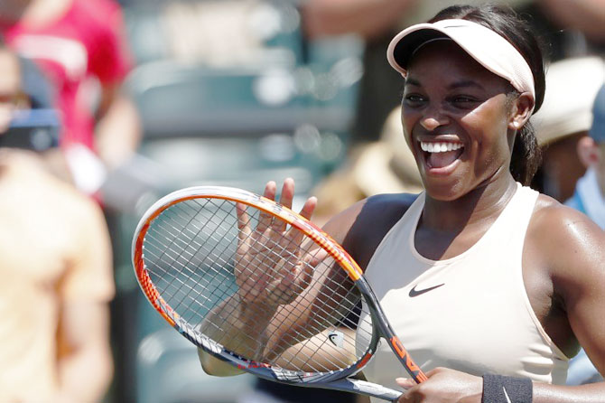 USA's Sloane Stephens smiles at her player's box after defeating Spain's Garbine Muguruza