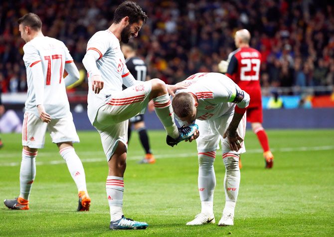 Spain's Isco celebrates with Sergio Ramos after scoring their third goal against Argentina at Wanda Metropolitano, Madrid, during their international friendly on Wednesday