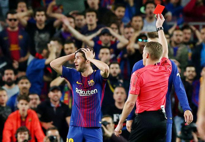 Barcelona's Sergi Roberto is shown a red card by referee Alejandro Hernandez during the Clasico against Real Madrid at Camp Nou on Sunday