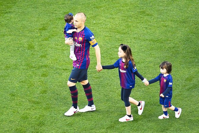 FC Barcelona's Andres Iniesta walks on the pitch with his daughters Valeria Iniesta and Siena Iniesta and his son Paolo Andrea Iniesta prior to the La Liga match between Barcelona and Real Sociedad at Camp Nou in Barcelona on Sunday