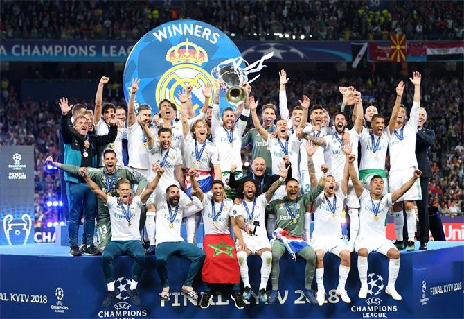 Real Madrid players celebrate with the trophy after defeating Liverpool 3-1 to win the UEFA Champions League final in May 2018