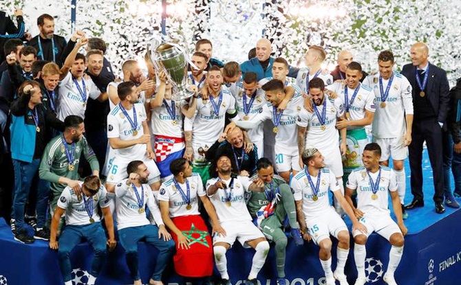 Real Madrid celebrate winning the Champions League with the trophy