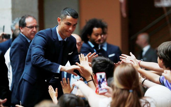 Real Madrid's Cristiano Ronaldo celebrates with fans
