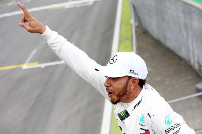 Pole position qualifier Lewis Hamilton of Great Britain and Mercedes GP celebrates in parc ferme during qualifying for the Formula One Grand Prix of Brazil at Autodromo Jose Carlos Pace in Sao Paulo, Brazil, on Saturday