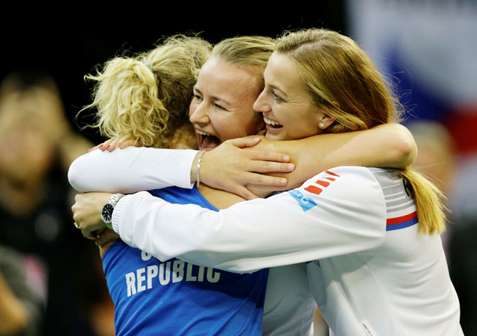 Czech Republic's Katerina Siniakova celebrates with Petra Kvitova and Barbora Krejcikova after winning her match against Sofia Kenin of the US to win the Fed Cup final at 02 Arena in Prague on Sunday