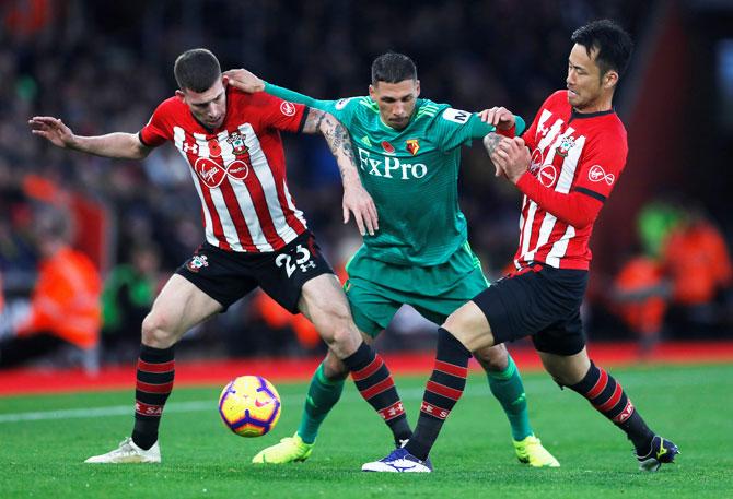 Southampton's Pierre-Emile Hojbjerg and Maya Yoshida challenge Watford's Jose Holebas(centre) during their match at St Mary's Stadium