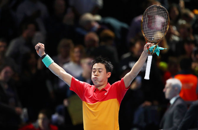Japan's Kei Nishikori celebrates after defeating Swiss Roger Federer in the ATP Tour Finals opener at O2 Arena in London on Sunday
