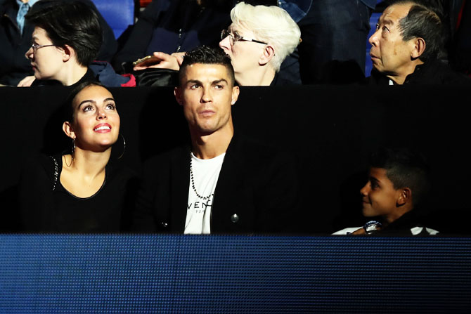 Juventus and Portuguese footballer Cristiano Ronaldo, his girlfriend Georgina Rodríguez and son Cristiano Ronaldo Jr. watch the ATP Tour Finals singles round robin match between Novak Djokovic and John Isner