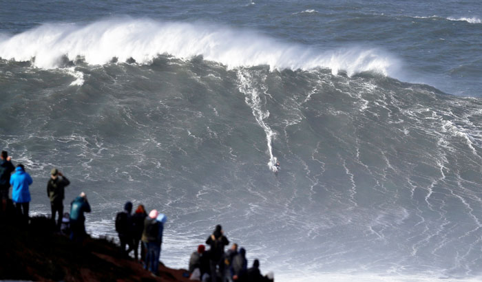 Big-wave surfer Sebastian Steudtner of Germany drops in a large wave at Praia do Norte in Nazare, Portugal on Friday, November 9