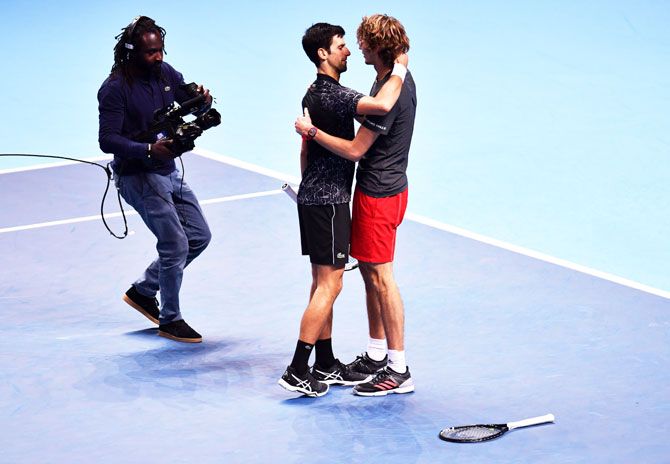 Germany's Alexander Zverev embraces Serbia's Novak Djokovic after victory in the final of the ATP Tour Finals at The O2 Arena in London on Sunday