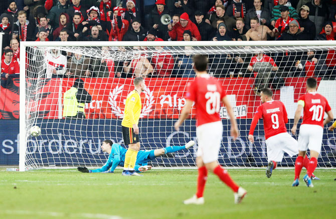 Switzerland's Haris Seferovic scores their fifth goal to complete his hat-trick in the match against Belgium