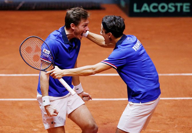 France's Pierre-Hugues Herbert and Nicolas Mahut celebrate winning their doubles match against Croatia's Ivan Dodig and Mate Pavic during the Davis Cup final at Stade Pierre Mauroy in Lille, France, on Sunday
