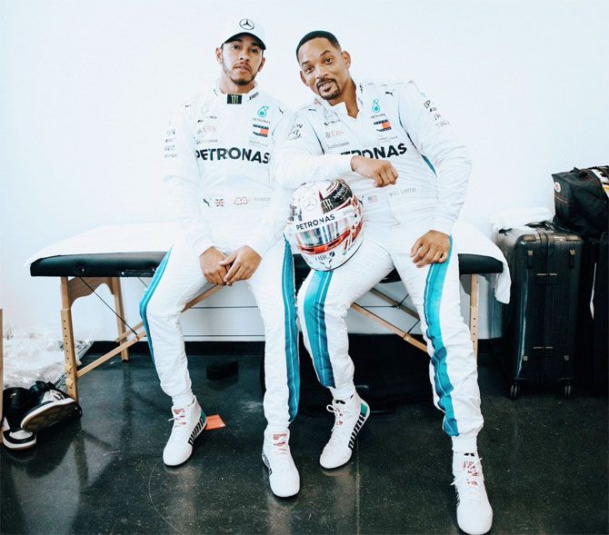 Lewis Hamilton with actor and Will Smith who brought down the chequered flag at the Yas Marina circuit at the Abu Dhabi Grand Prix on Sunday