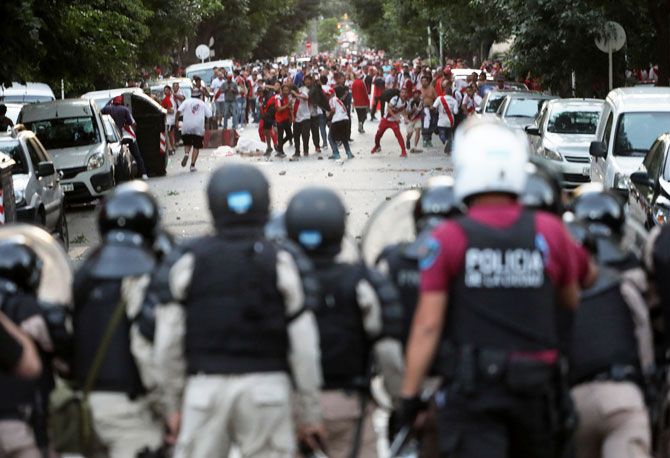 River Plate's fans clash with riot police after the match betweeb River Plate and Boca Juniors was postponed in Buenos Aires in Argentina on Sunday
