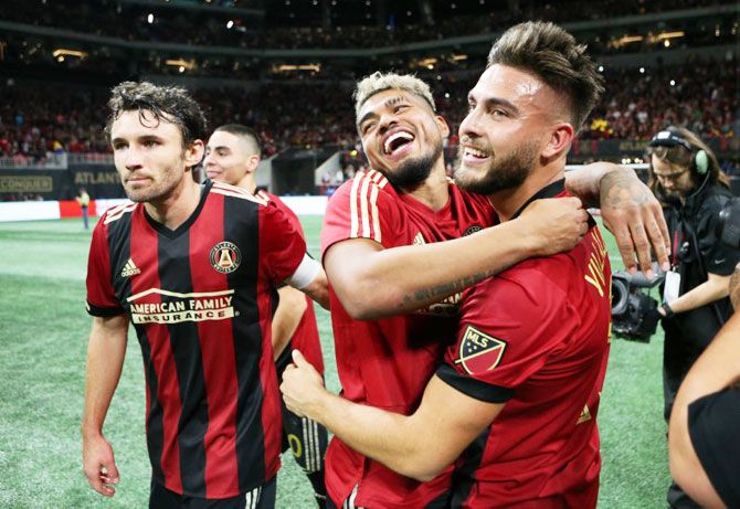 Atlanta United forward Josef Martinez (center) hugs teammate Hector Villalba (15) after the first leg of the MLS Eastern Conference Championship against the New York Red Bulls at Mercedes-Benz Stadium in Atlanta on Sunday