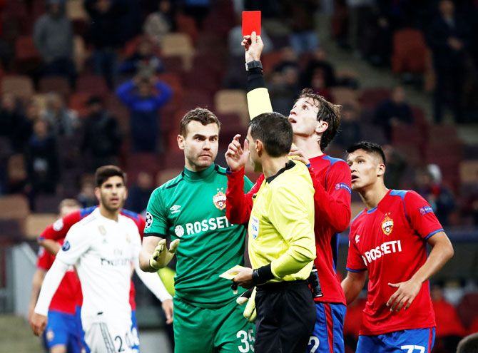 CSKA Moscow's Igor Akinfeev is shown a red card by referee Ovidiu Hategan just before the full-time whistle