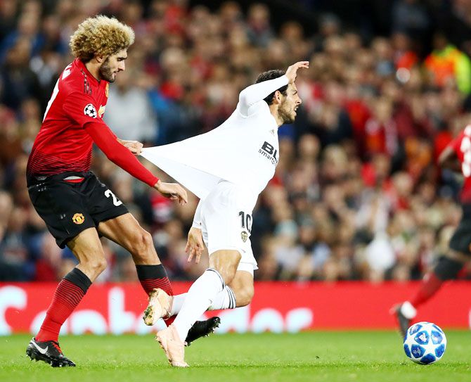 Valencia's Daniel Parejo is challenged by Manchester United's Marouane Fellaini