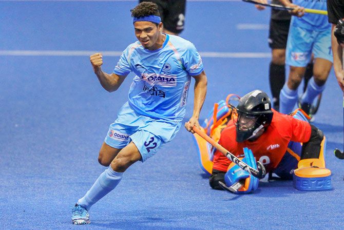 India's Shilanand Lakra celebrates after scoring a goal against New Zealand in the 8th Sultan of Johor Cup hockey tournament in Johor Bahru, Malaysia, on Sunday
