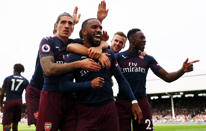 Arsenal's players celebrate after Alexandre Lacazette, centre, scored their second goal