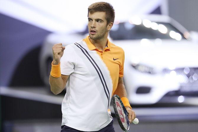 Borna Coric celebrates a point against Roger Federer