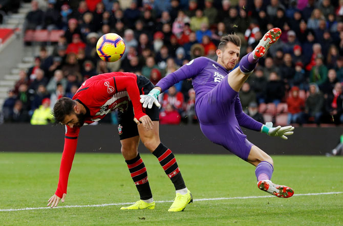 Southampton's Charlie Austin and Newcastle United's Martin Dubravka collide as they go for the ball
