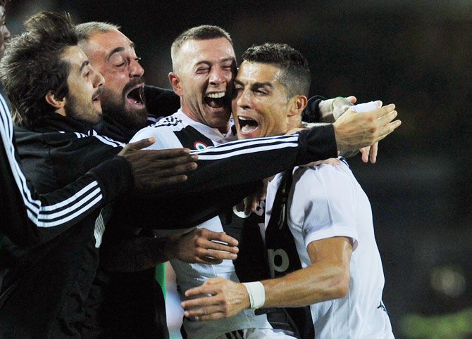 Juventus' Cristiano Ronaldo celebrates scoring their second goal with Federico Bernardeschi and teammates during their Serie A match against Empoli on Saturday