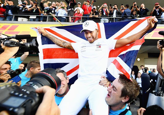 Mercedes GP's British driver Lewis Hamilton celebrates with his team on winning the F1 World Drivers Championship after the Formula One Grand Prix of Mexico at Autodromo Hermanos Rodriguez in Mexico City, Mexico on Sunday 