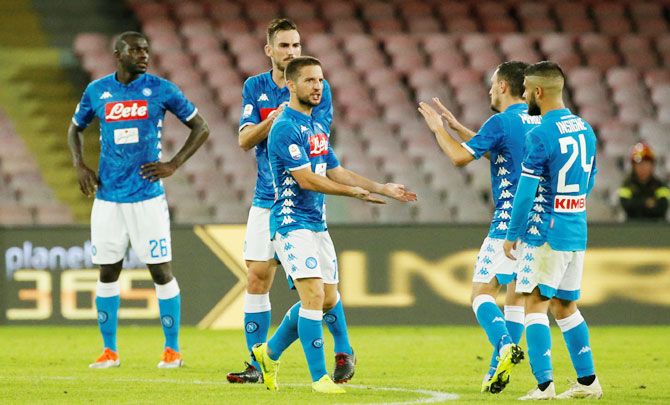Napoli's Dries Mertens celebrates with teammates after scoring their first goal against AS Roma in their Serie A match at Stadio San Paolo in Naples, Italy on Sunday