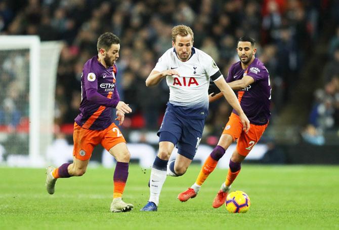 Tottenham Hotspur's Harry Kane is challenged Manchester City's Bernardo Silva (left) and Riyadh Mahrez