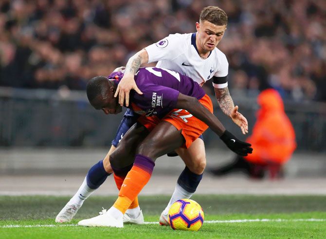 Tottenham Hotspur's Kieran Trippier challenges Manchester City's Benjamin Mendy as they vie for possession