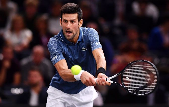 Serbia's Novak Djokovic plays a backhand return against Portugal's Joao Sousa during his second round match on Day 2 of the Rolex Paris Masters in Paris on Tuesday
