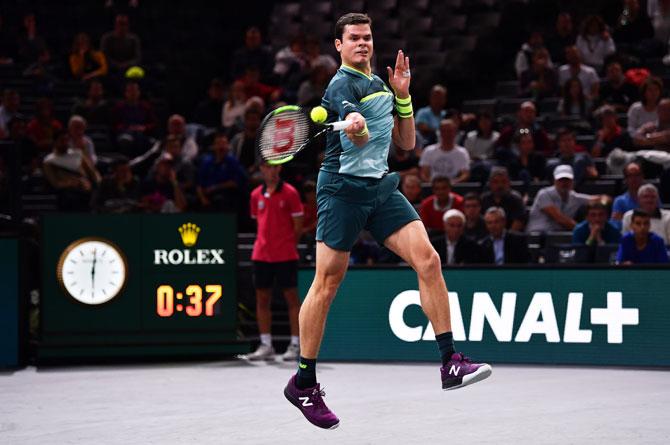 vCanada'a Milos Raonic plays a forehand against Jo-Wilfried Tsonga