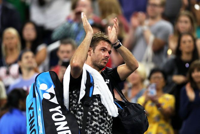 Switzerland's Stan Wawrinka applauds fans following his defeat to Canada's Milos Raonic during the US Open third round match at the USTA Billie Jean King National Tennis Center in New York on Friday