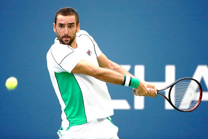 Croatia's Marin Cilic returns the ball during the men's singles fourth round match against Belgium's David Goffin