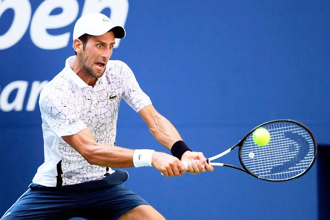 Serbia's Novak Djokovic returns the ball during his men's singles fourth round match against Portugal's Jaoa Sousa at the USTA Billie Jean King National Tennis Center on Sunday