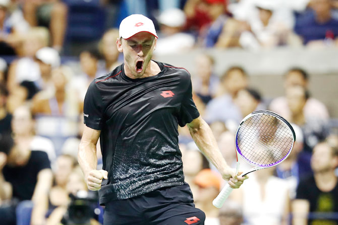 John Millman is pumped up on winning a point against Roger Federer
