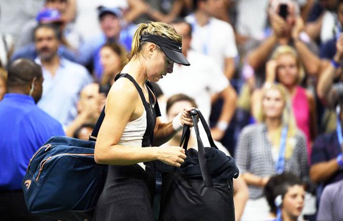 Russia's Maria Sharapova walks off the court after losing her fourth round match against Spain's Carla Suarez Navarro on Monday