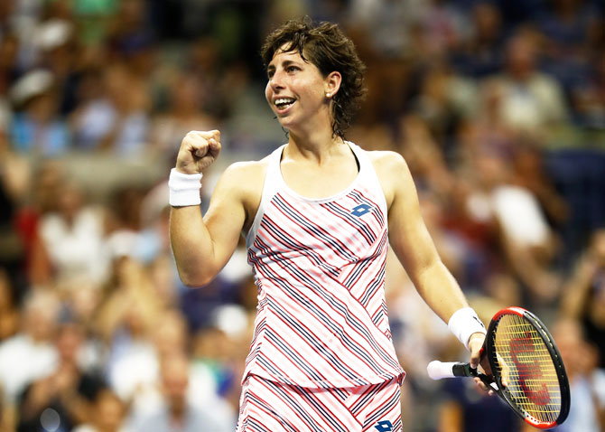 Carla Suarez Nevarro celebrates match point against Maria Sharapova