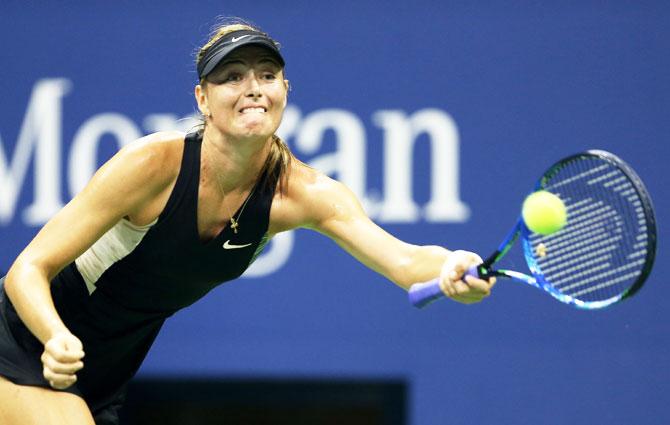 Maria Sharapova stretches to play a return against Carla Suarez Nervarro