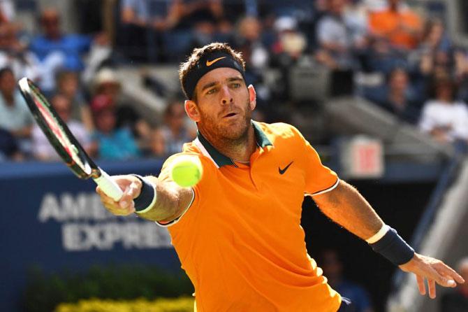 Argentina's Juan Martin del Potro hits a return to USA's John Isner in their quarter-final at the USTA Billie Jean King National Tennis Center