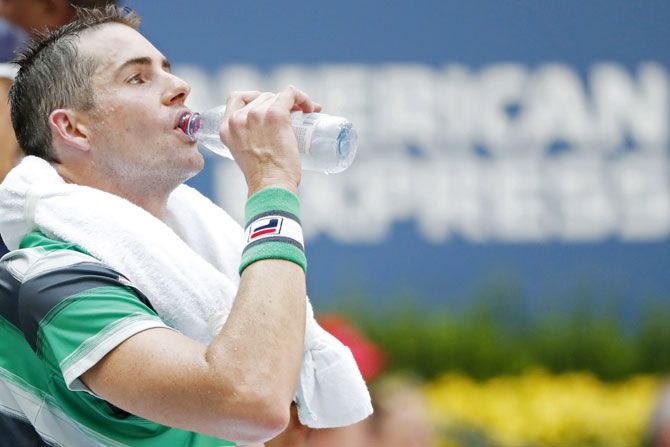 A drained out John Isner during a changeover in the quarter-final against Juan Martin Del Potro on Tuesday
